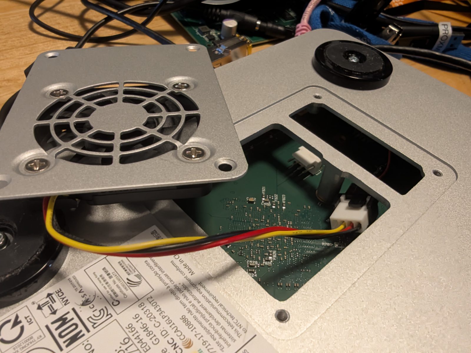 The fan on its metal mounting plate, plugged into the new header inside the case